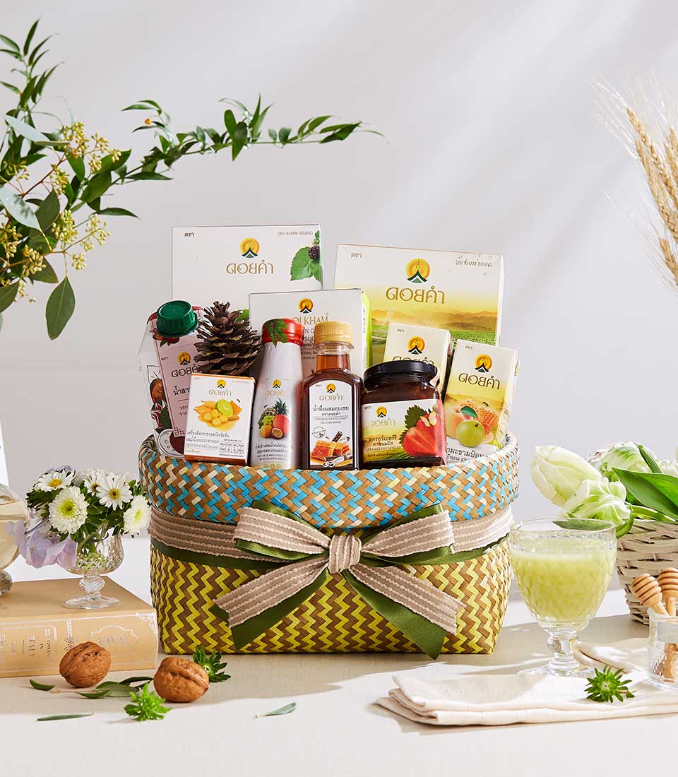 Heritage Doi Kham woven gift basket filled with premium gourmet foods, jam, and wellness products with striped ribbon bow