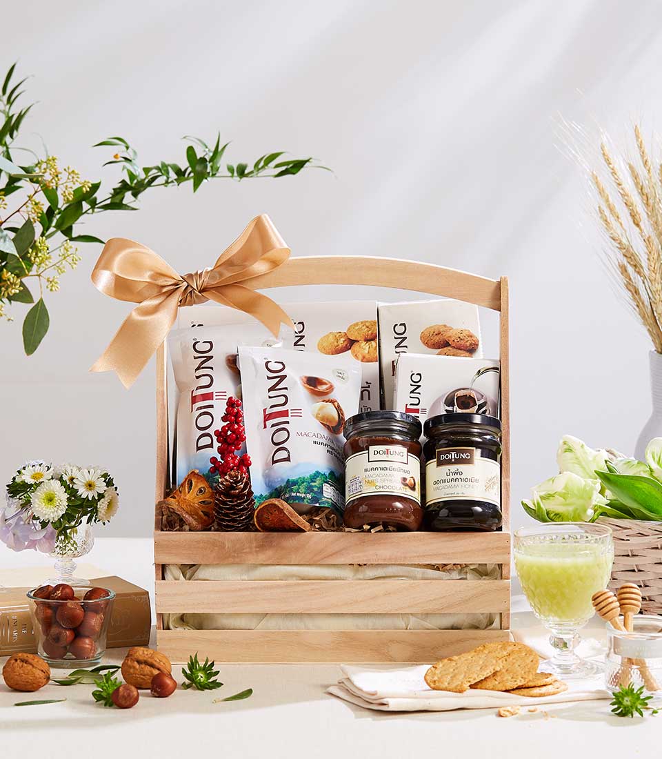 Doi Tung premium gift basket with nuts, honey, and gourmet treats, tied with gold satin bow