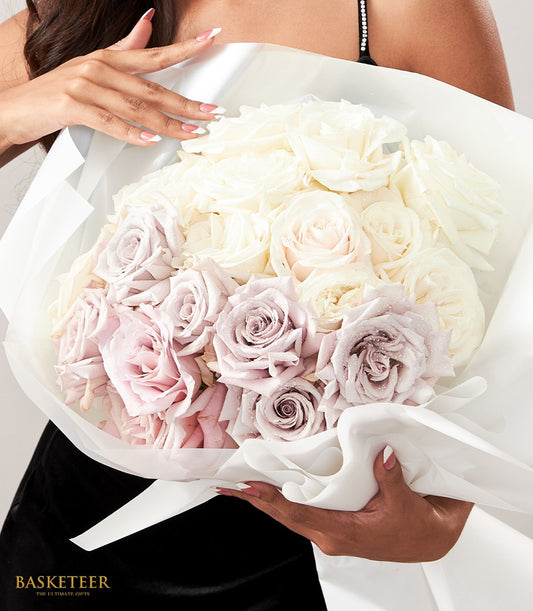 Elegant rose bouquet in cream, peach, dusty pink and mauve with white wrapping, perfect anniversary gift for her