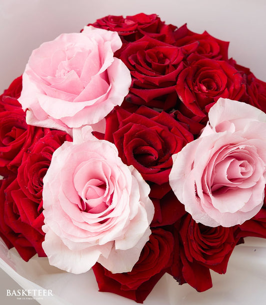 Lush red and pink rose bouquet with fresh petals, romantic anniversary flowers