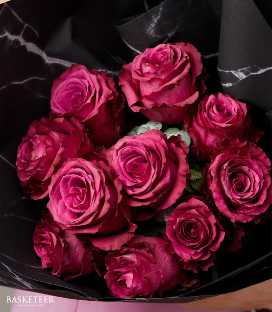 Deep fuchsia roses bouquet with black marble wrapping, perfect for anniversaries and romantic occasions