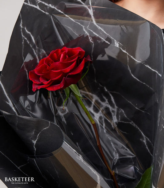 Single red rose bouquet from Flowers by Basketeer, elegantly wrapped in black marble-patterned cellophane. Perfect for flower delivery Bangkok.