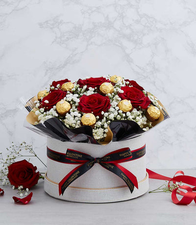 Premium red roses and Ferrero Rocher chocolates in textured grey gift box with baby's breath