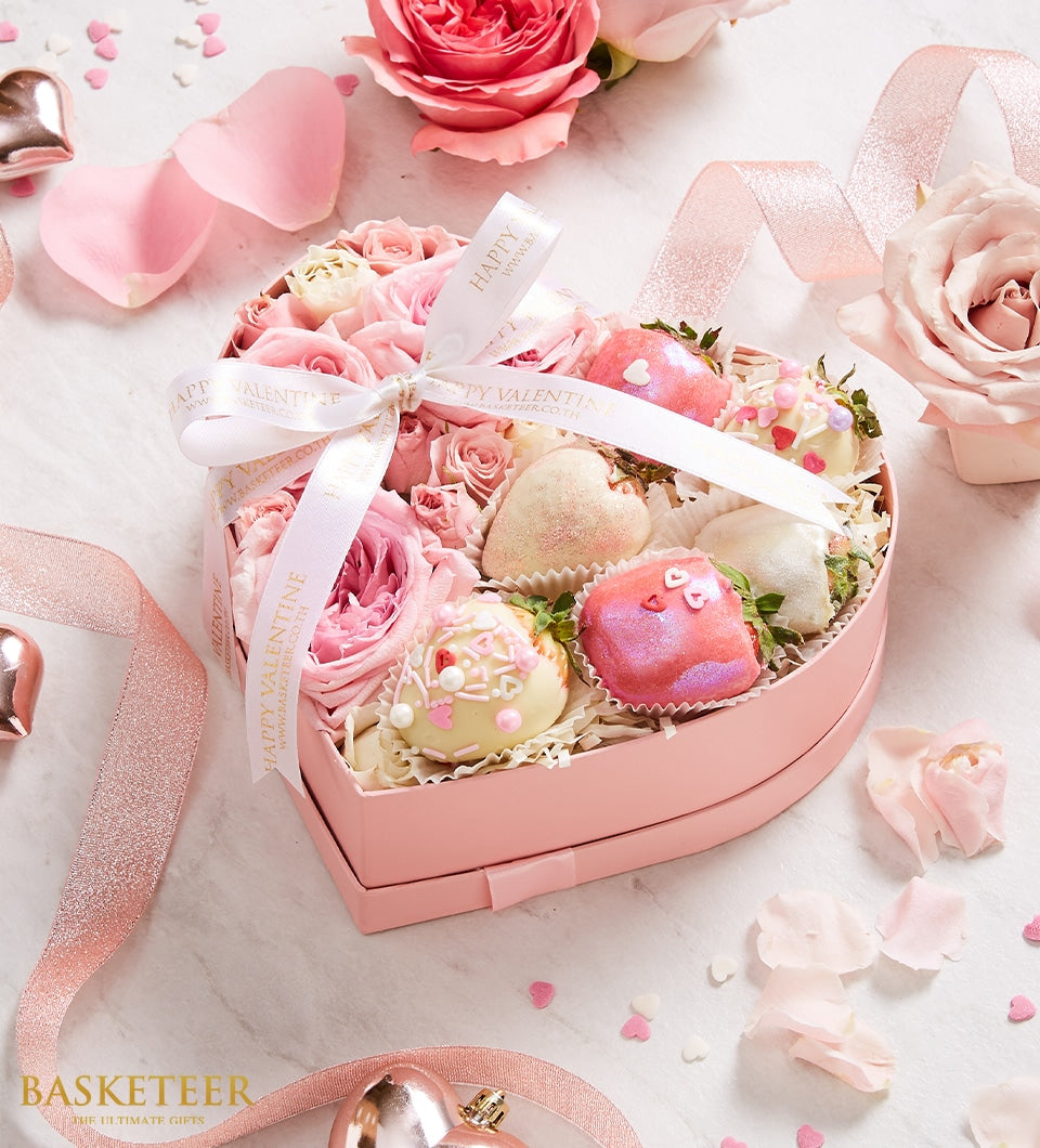 Heart-shaped gift box with pink roses and assorted chocolate-covered strawberries in white, pink, and gold coatings