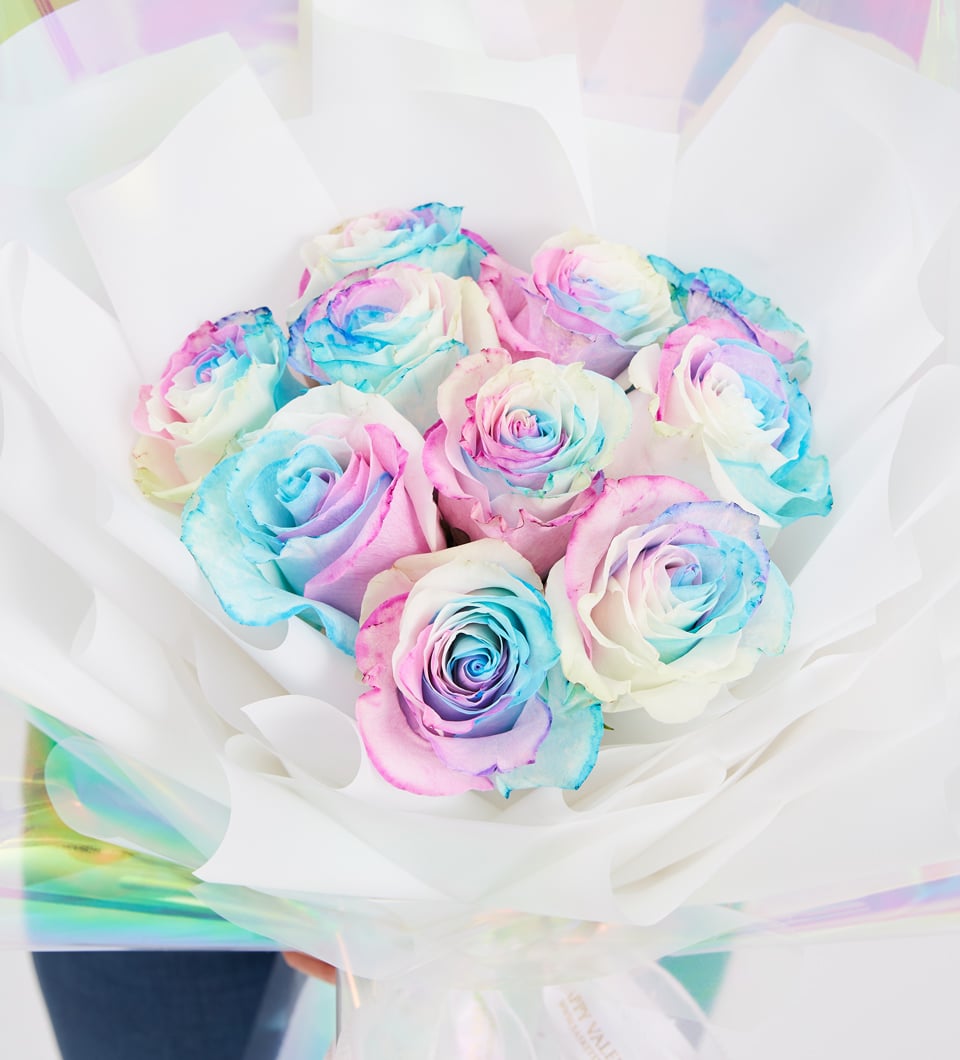 Pastel rainbow rose bouquet with pink, blue and white petals in iridescent wrap, perfect anniversary gift for her