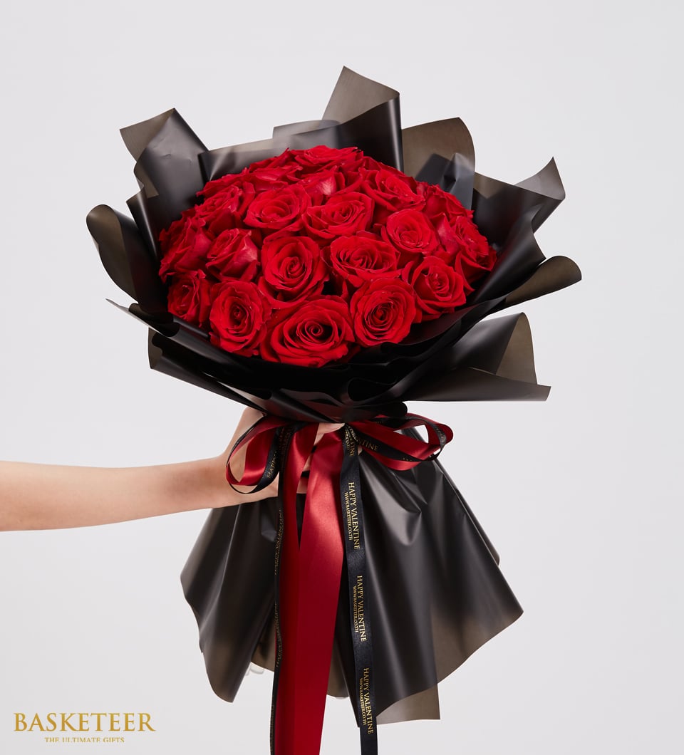 Luxury red rose bouquet with black matte wrapping and red satin ribbon, perfect for anniversaries and romantic occasions