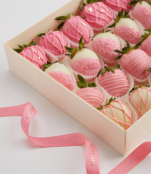 Luxury chocolate-covered strawberries in pink and white with gold accents, gift-boxed for birthdays