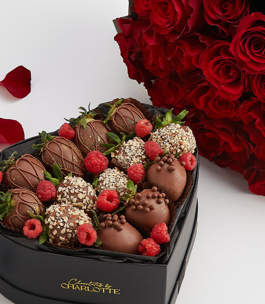 Dark chocolate strawberries and fresh red roses in heart-shaped gift box, Valentine's Day luxury gift set