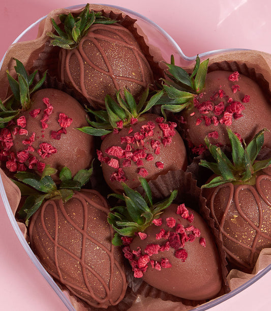 Dark chocolate-covered strawberries with gold glitter in heart-shaped Valentine gift box from Charlotte Bakery