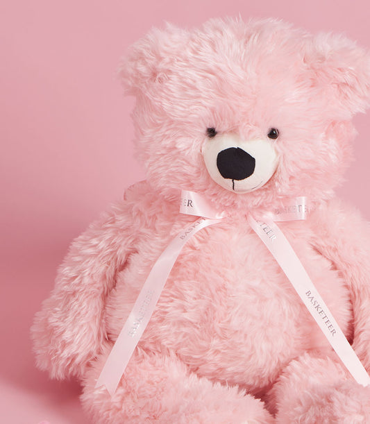 Fluffy pink teddy bear with Basketeer ribbon, a sweet gift for Valentine's Day. Premium hamper delivery in Thailand.