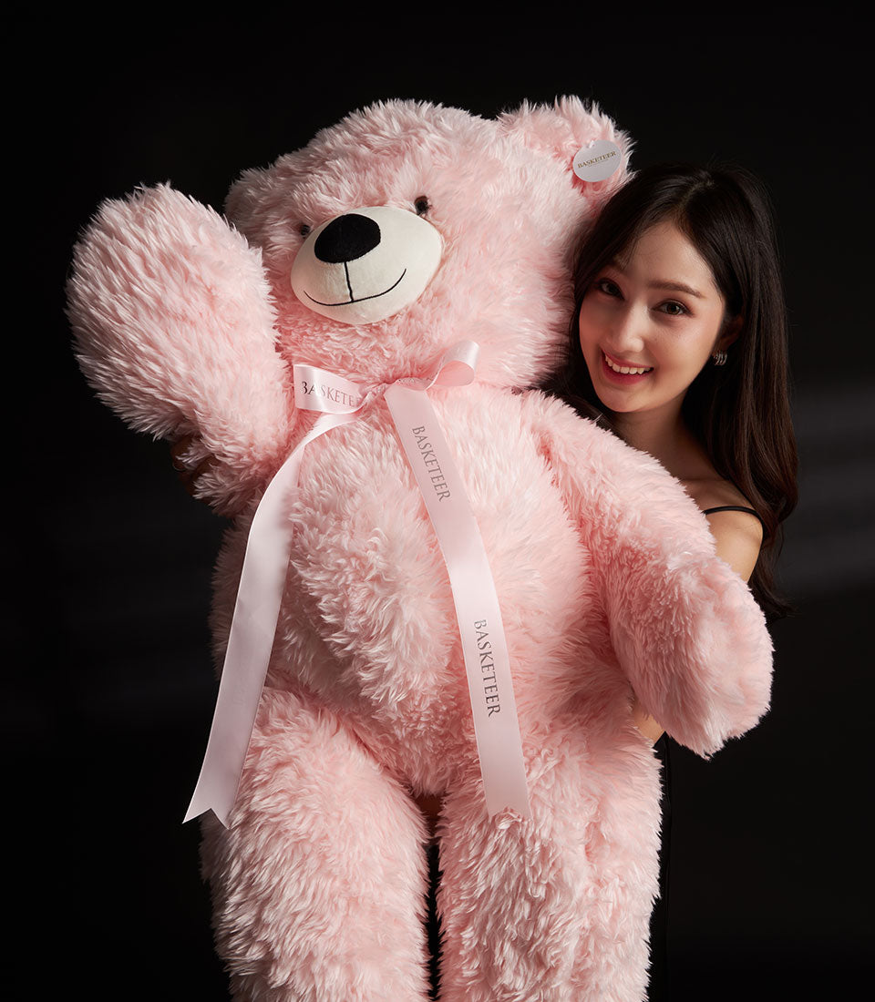 Giant, fluffy pink teddy bear with Basketeer ribbon - a warm and generous romantic gift for Valentine's Day. Premium hamper delivery Thailand.
