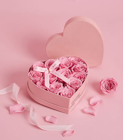 Pink preserved roses in heart-shaped gift box, elegant Valentine's Day flower gift