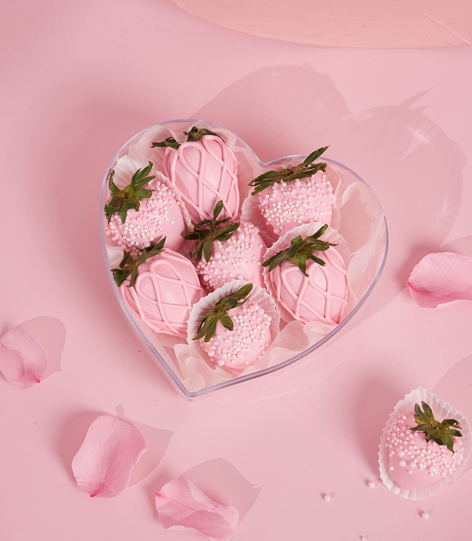 Charlotte Bakery's artisan chocolate covered strawberries in a heart-shaped box. Pink candy coating with white sprinkles, perfect for a Valentine's custom cake Bangkok delivery.