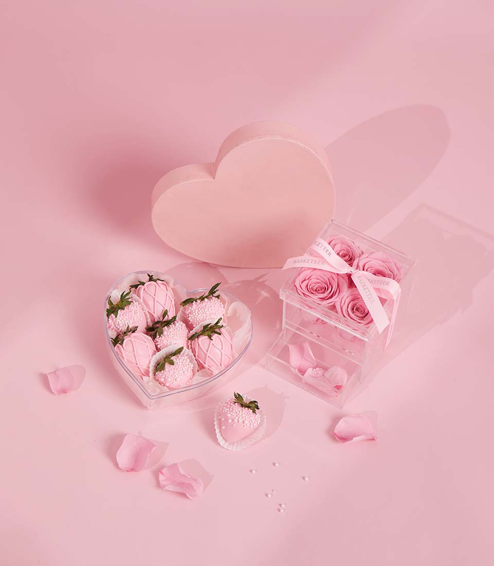 Pink chocolate-covered strawberries and preserved roses Valentine gift set with white ribbon
