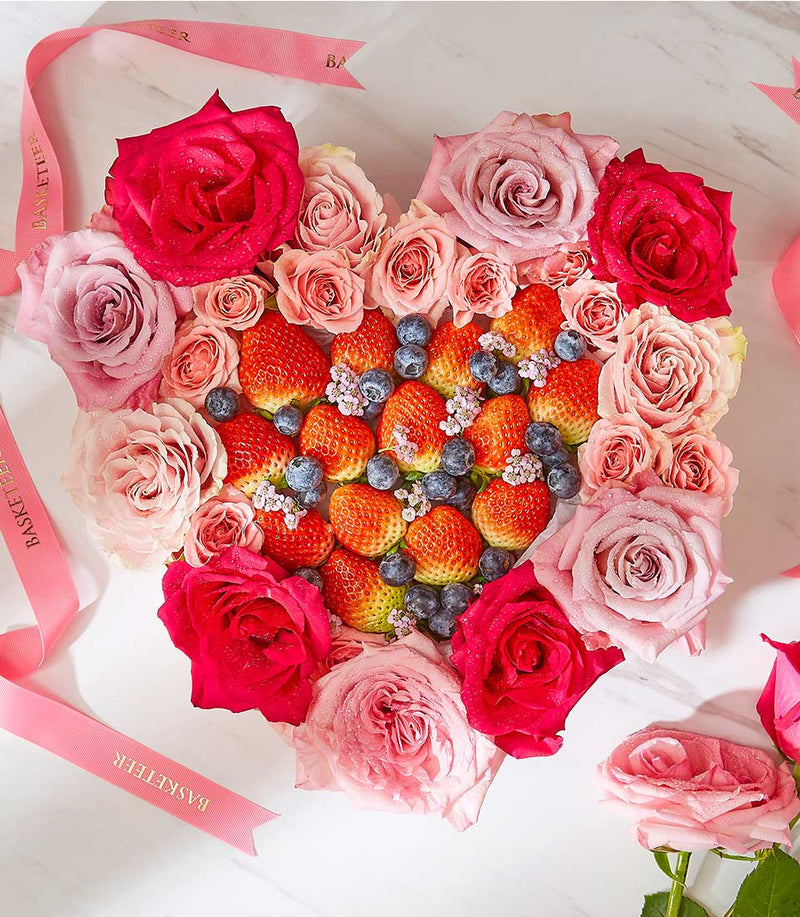 Heart-shaped fresh berry and rose surprise box with strawberries, blueberries, and fuchsia pink roses