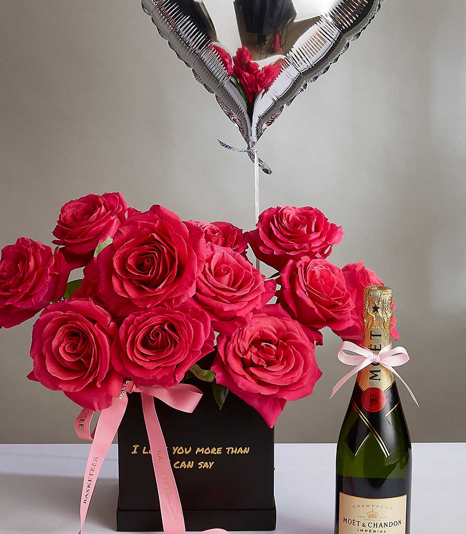 Luxury Valentine's gift set with dozen red roses, champagne bottle, and silver heart balloon