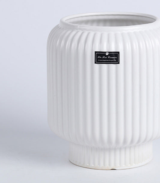 White textured ceramic vase with ribbed fluted design, elegant cylinder shape perfect for fresh flowers or home decor