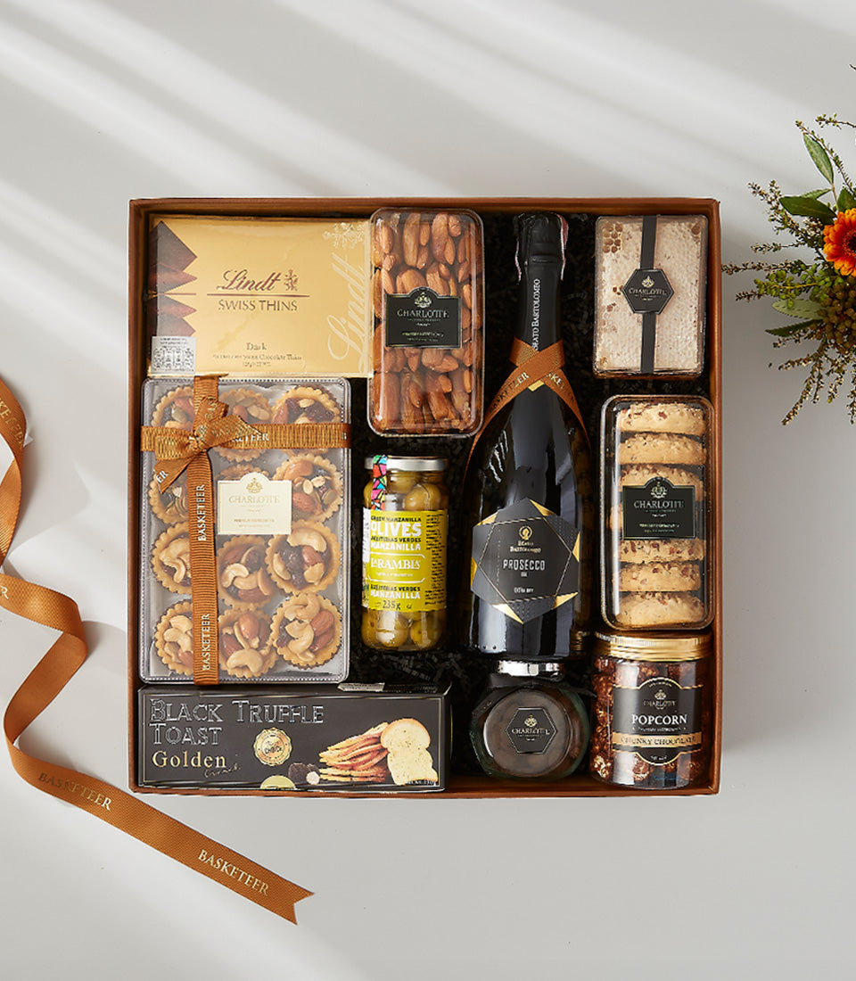 Premium Diamante Breganze Prosecco gourmet gift box with chocolate, almonds, truffle toast, and fresh flowers