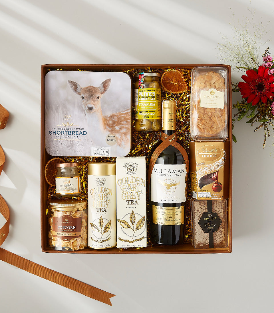 Premium wine and gourmet snacks gift hamper in wooden box with shortbread, chocolates, and red wine