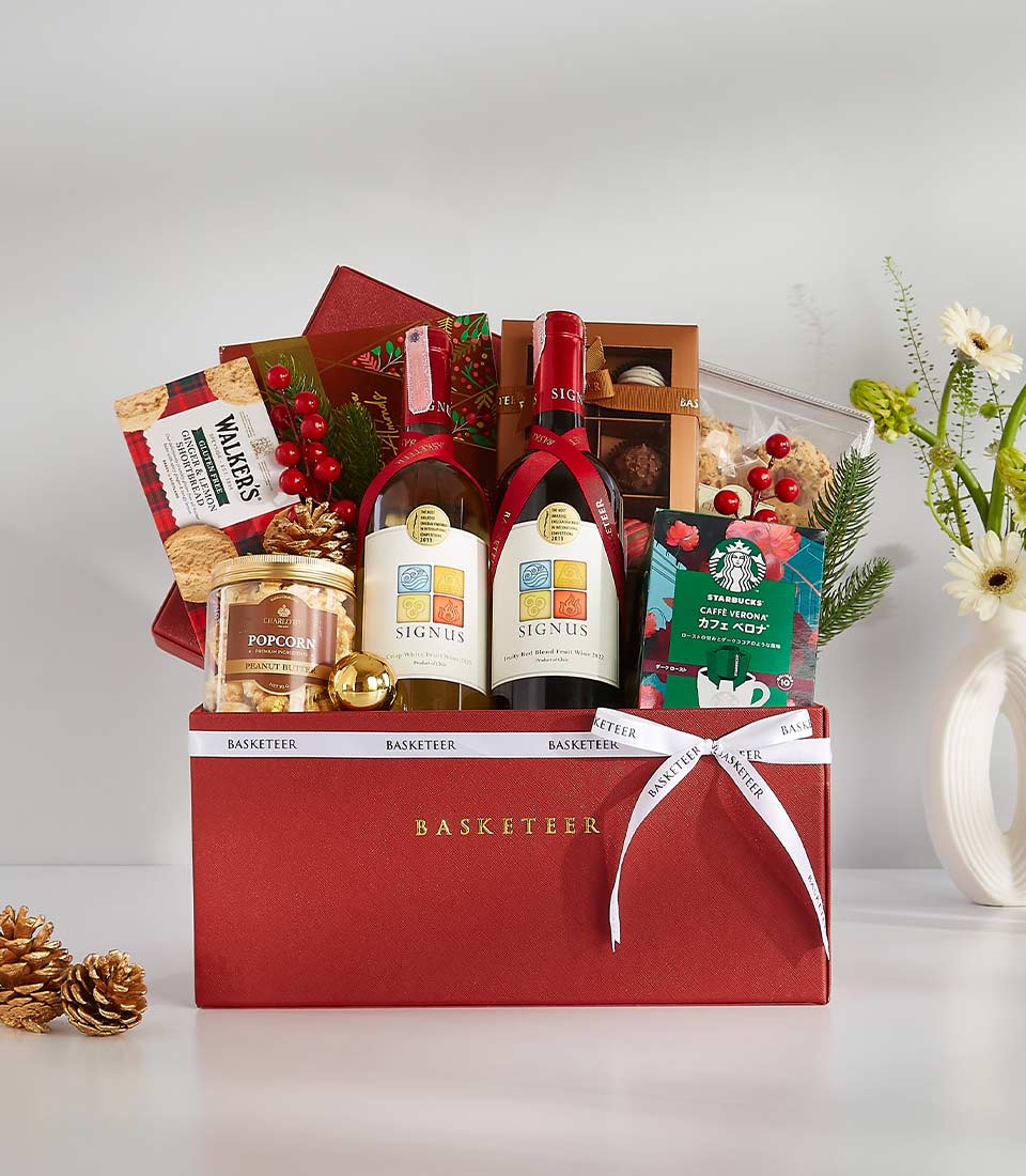 Luxury red gift hamper with red and white wine, gourmet snacks, and artisan chocolates, tied with white ribbon