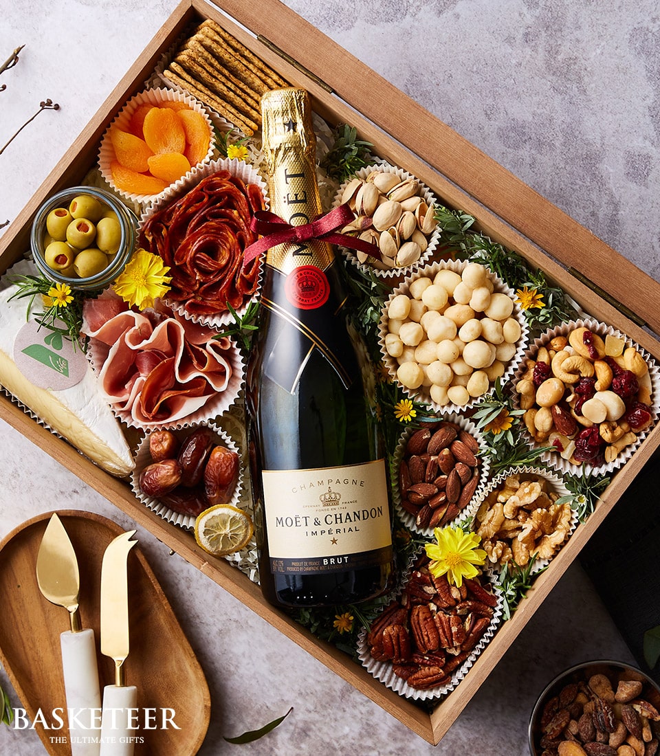 Moët & Chandon champagne gourmet hamper with cheese, nuts, cured meats, and crackers in luxury gift box
