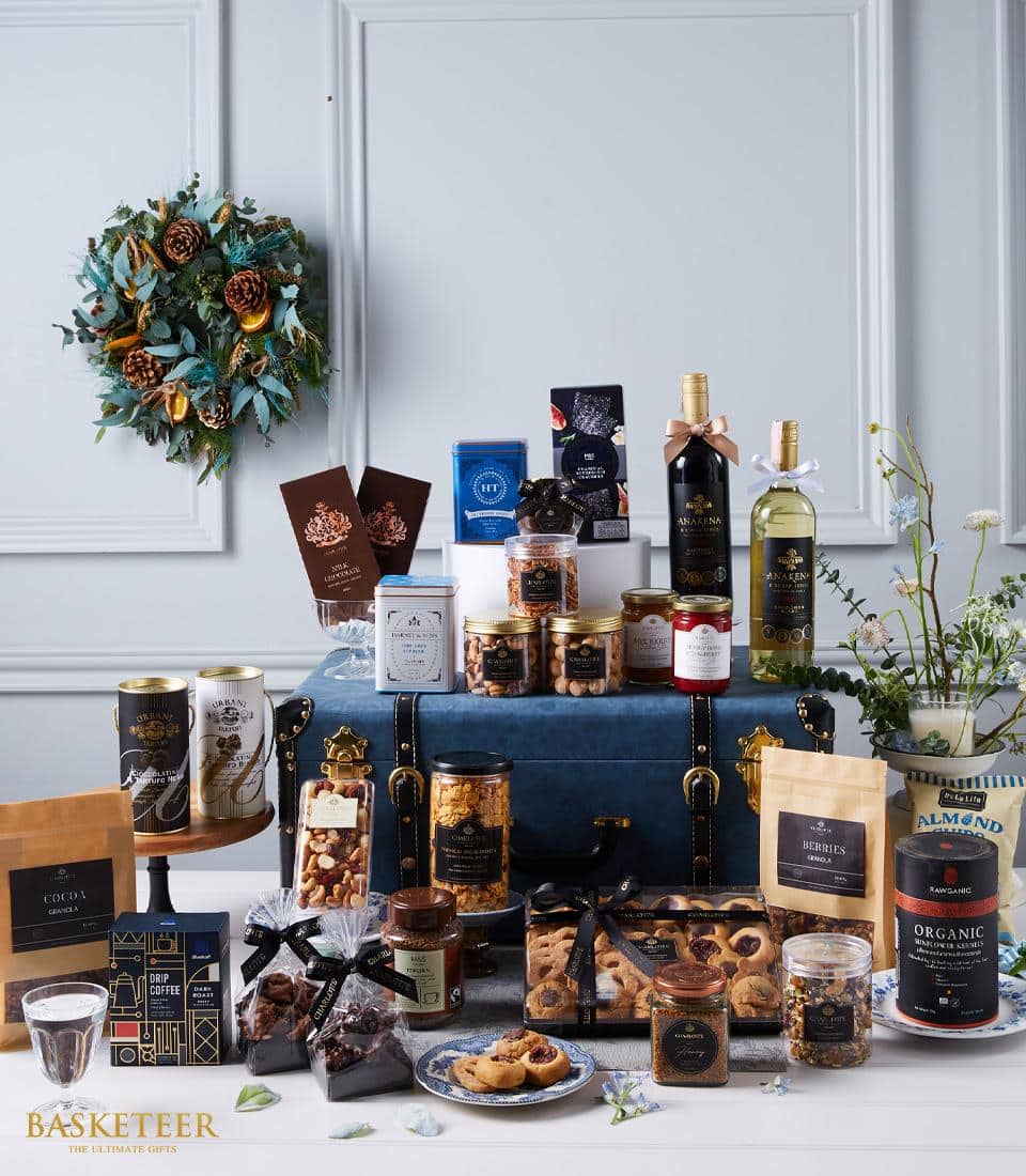 Premium wine and artisan snacks luxury hamper in leather trunk with gourmet chocolates, nuts, and jams