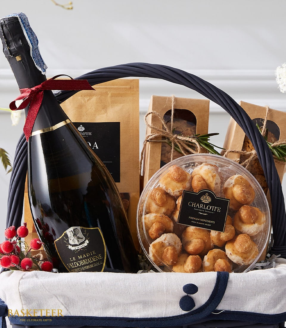 Premium Prosecco gift basket with gourmet pastries, artisan treats, and festive greenery for Christmas