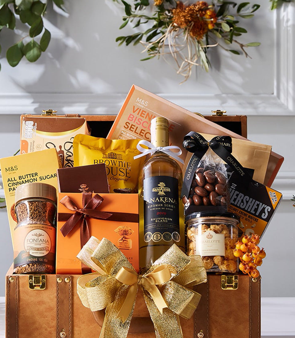 Premium white wine and gourmet treats luxury hamper in leather-look trunk with gold accents