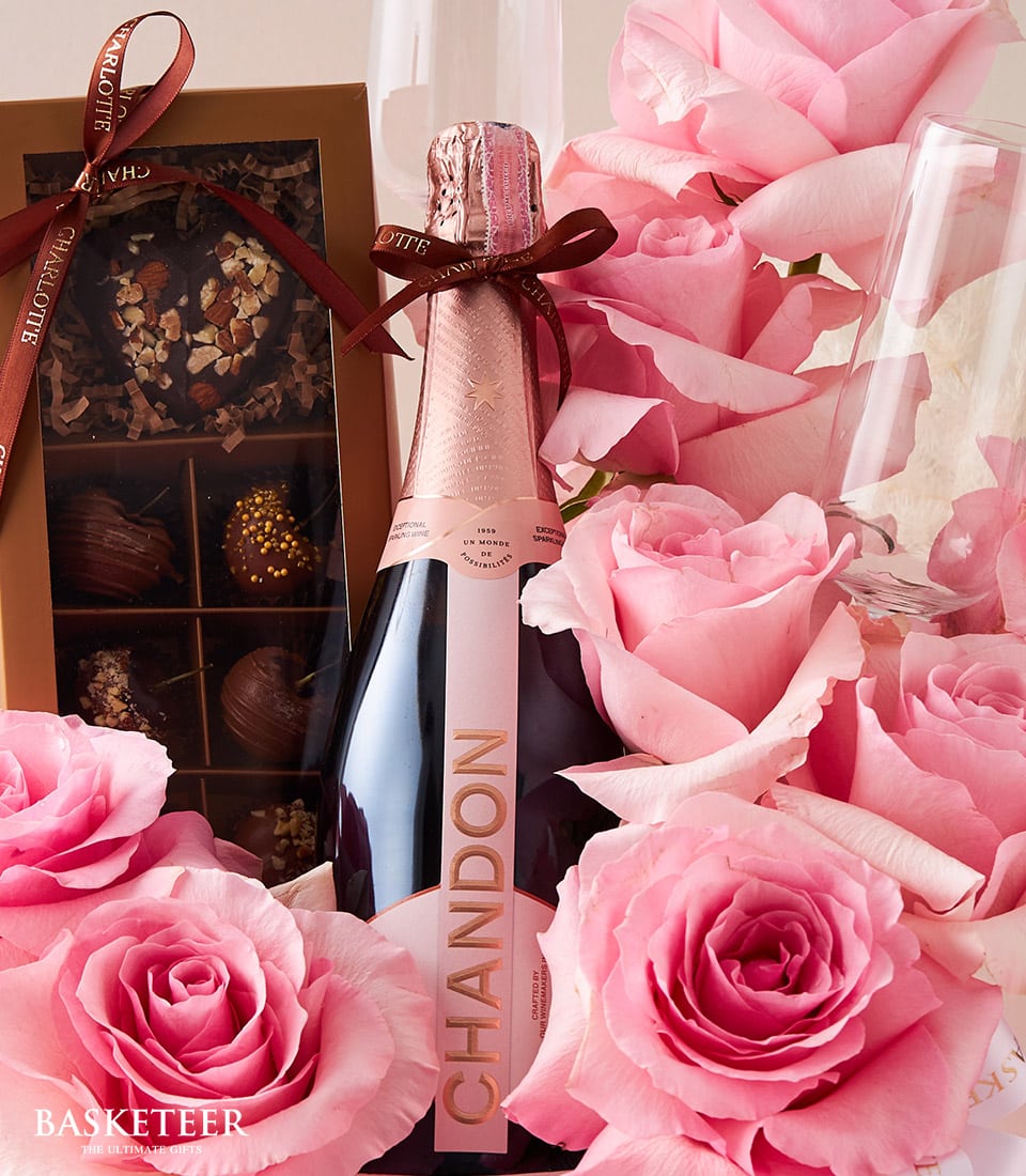 Pink roses, Chandon sparkling wine, and gourmet chocolates anniversary gift set with champagne flutes