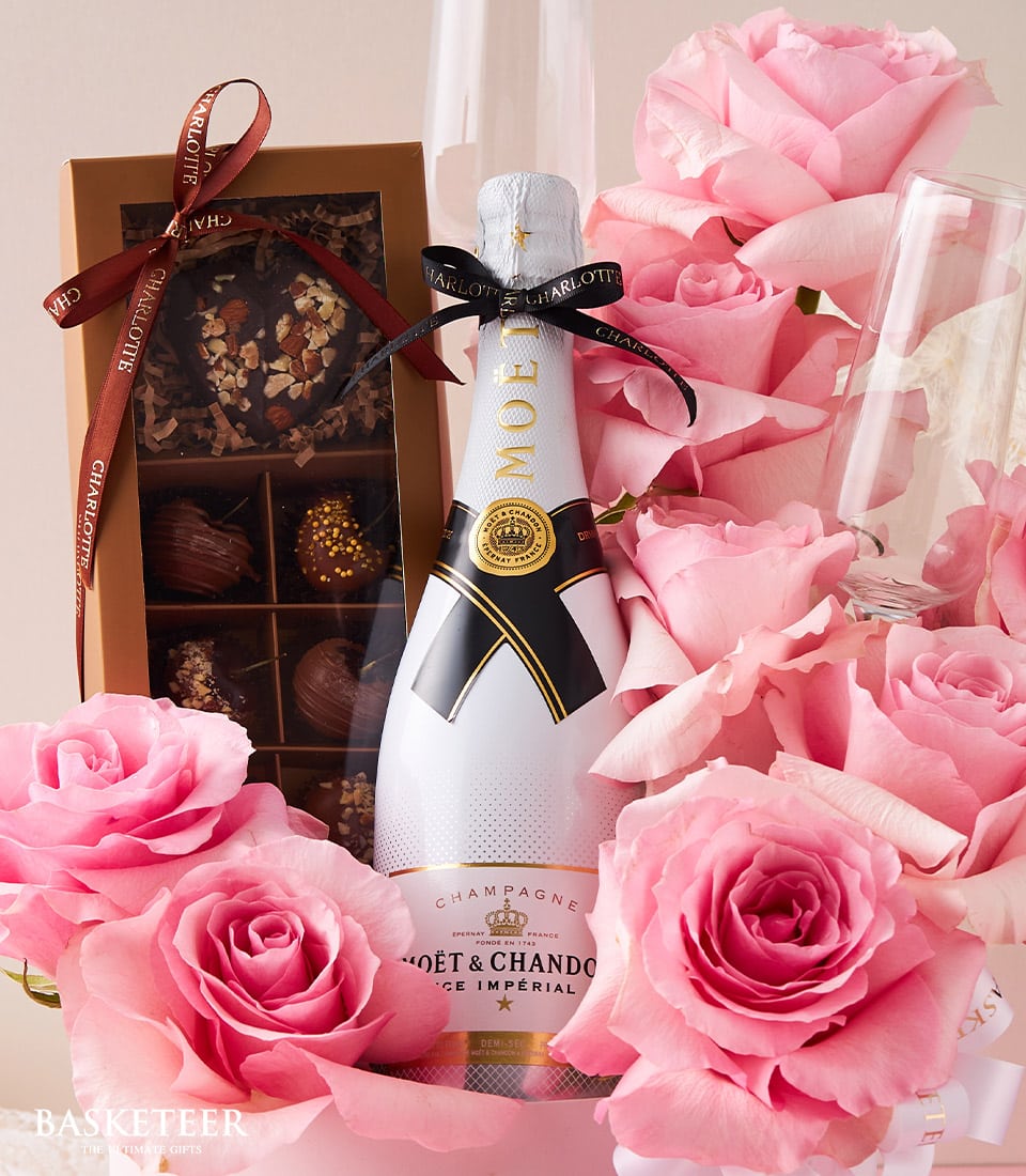 Moët champagne, pink roses, and Charlotte chocolates anniversary gift set with champagne flutes