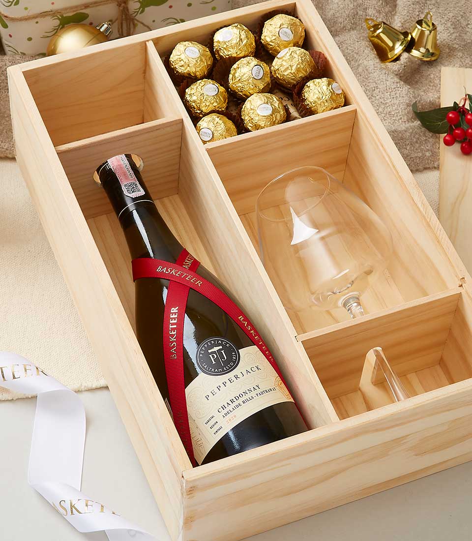 Wooden wine gift box with Pepperjack Chardonnay, stemmed glass, and gold-foil chocolates