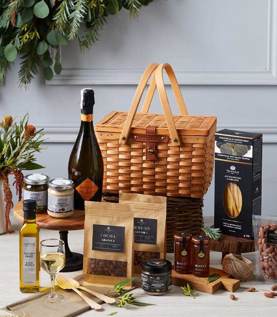 Luxury wicker hamper with Prosecco, truffle spreads, artisan pasta, and gourmet snacks for elegant gifting