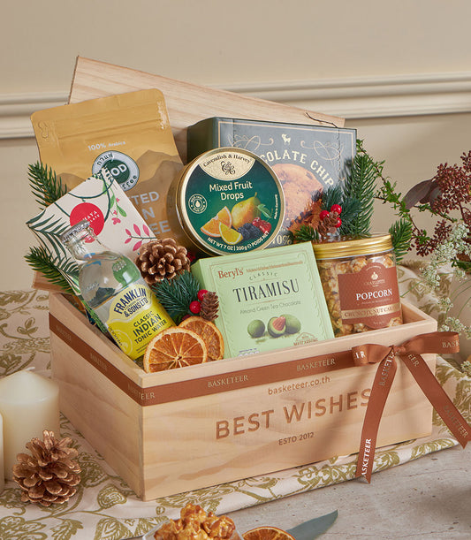 Warm wooden gift basket with gourmet coffee, tea, and treats tied with brown ribbon for New Year celebration