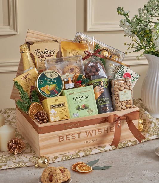 Golden luxury gourmet gift hamper with chocolates, coffee, and festive treats in wooden box for New Year