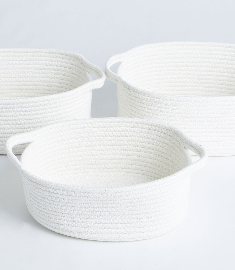 White cotton rope storage baskets with integrated handles in three sizes