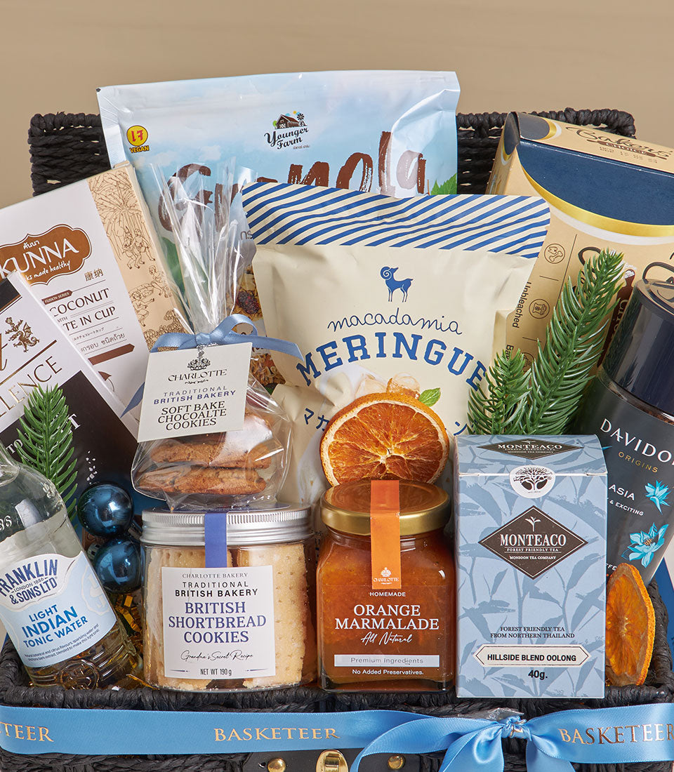 Blue satin ribbon gift basket with granola, tea, marmalade, and gourmet treats for New Year gifting