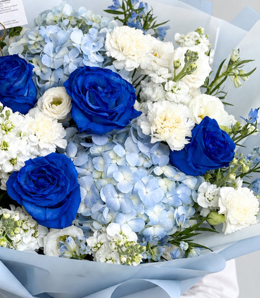Basketeer luxury bouquet with vibrant blue roses, soft blue hydrangeas,
