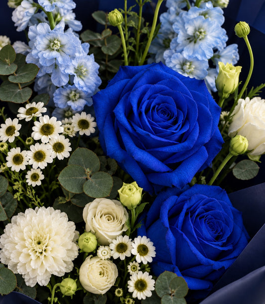 A luxurious Flowers by Basketeer rose bouquet featuring vibrant blue roses, delicate