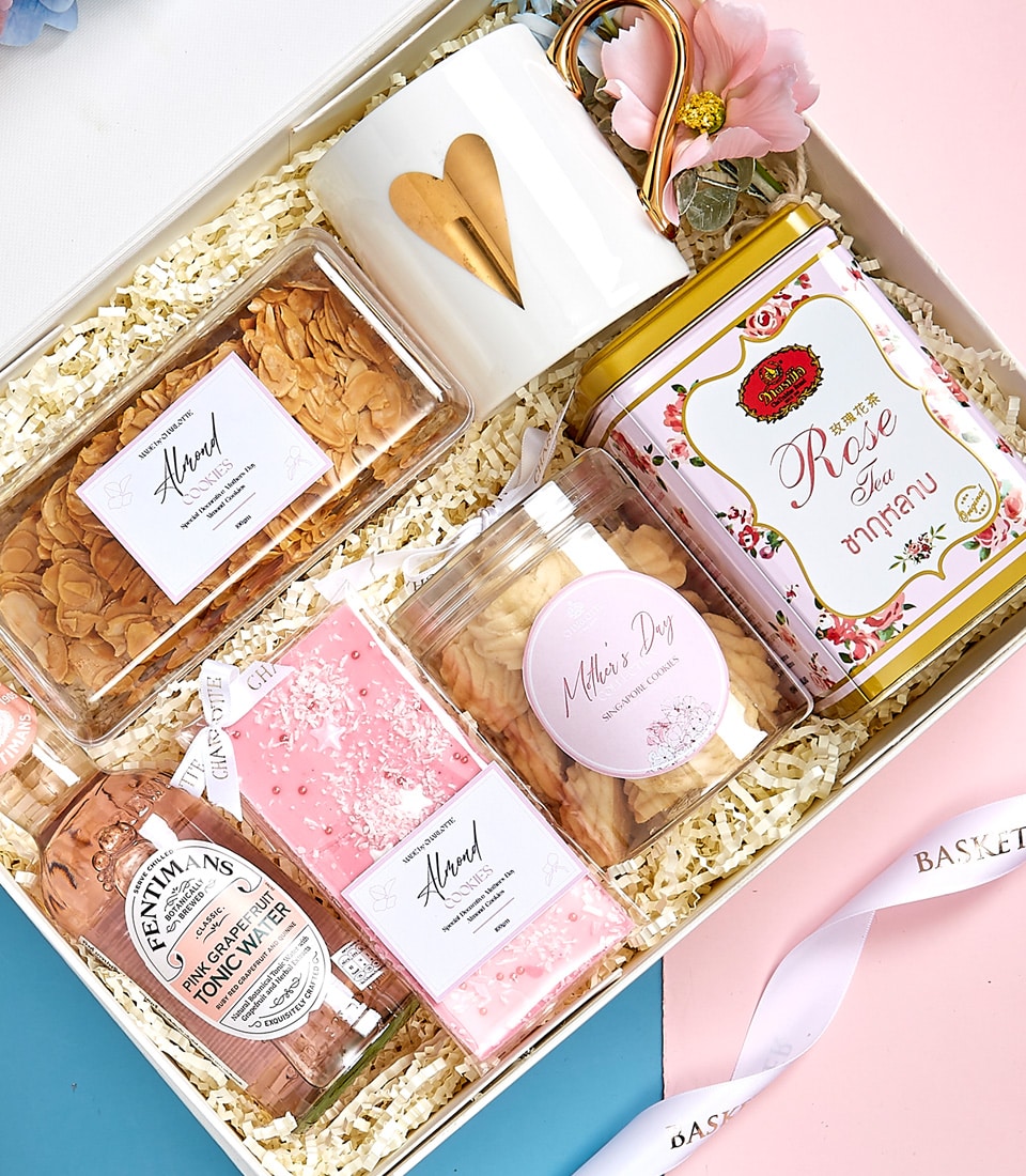 Luxury Mother's Day gift set with gold heart mug, rose tea, almond cookies, and premium tonic water