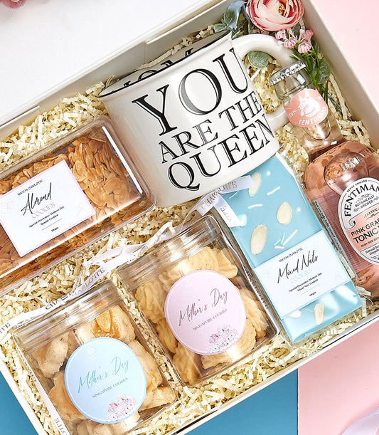 Mother's Day gift set with ceramic mug, gourmet cookies, nuts, and pink grapefruit tonic in white presentation box