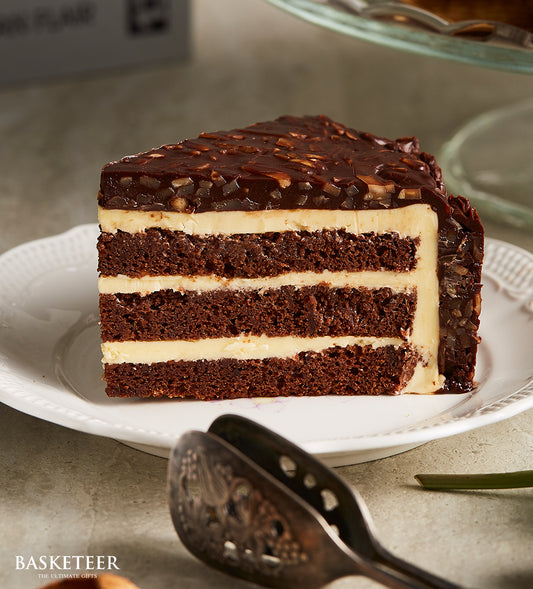 Rich Swiss chocolate layer cake with cream filling and glossy nut topping, artisan birthday dessert