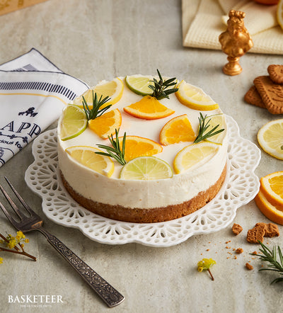 Lemon curd cheesecake with citrus garnish and rosemary on ceramic plate, artisan birthday cake