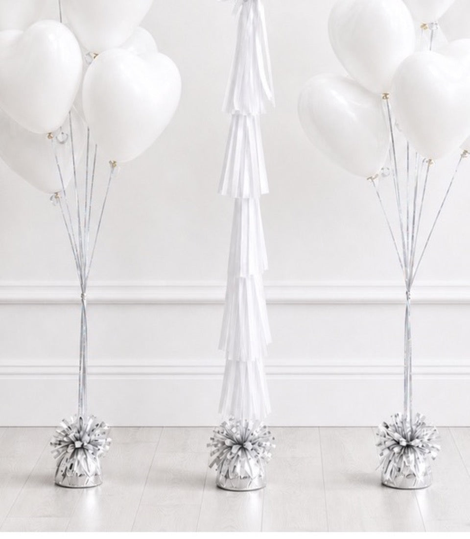 Three white balloon bouquets with silver string and weighted bases, accompanied by a white tissue paper tassel decoration.