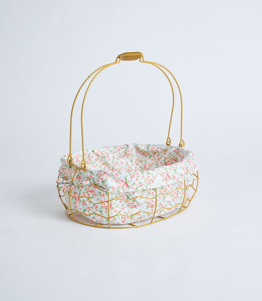 Gold oval wire basket with floral fabric lining and handle for premium gift presentation