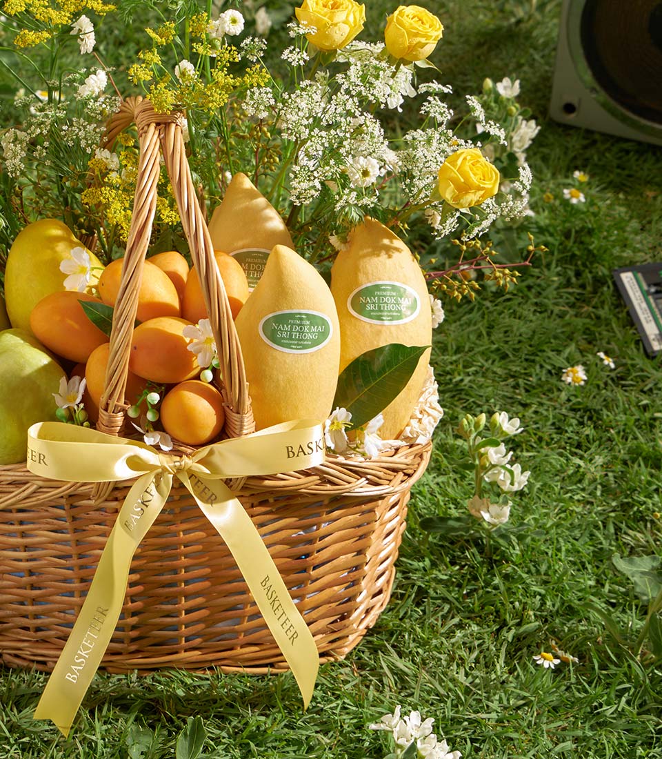 Premium mango and tropical fruit gift basket with yellow roses and white filler flowers