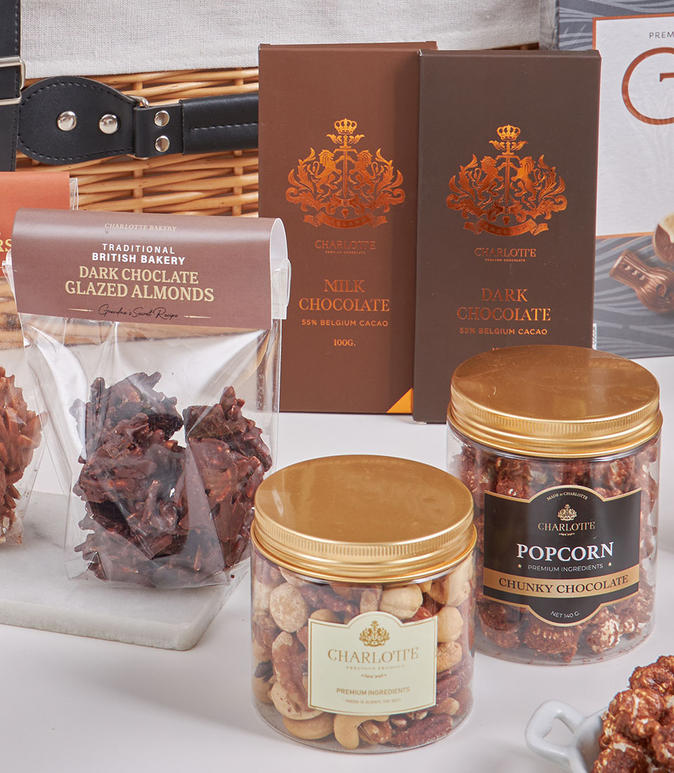 Basketeer premium hamper detail: Belgian chocolate bars, dark chocolate almonds, and chunky chocolate popcorn in a luxury gift basket. Perfect corporate gift!