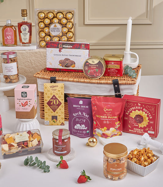 Premium gourmet gift hamper with chocolates, tea, cookies, honey, and artisan treats in wicker basket for New Year