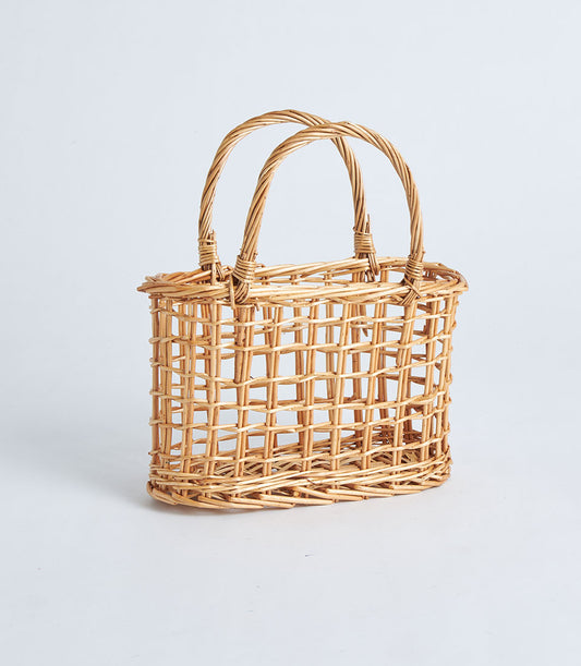 Light brown wicker basket with arched handles, open weave design for gift hampers and curated gifting