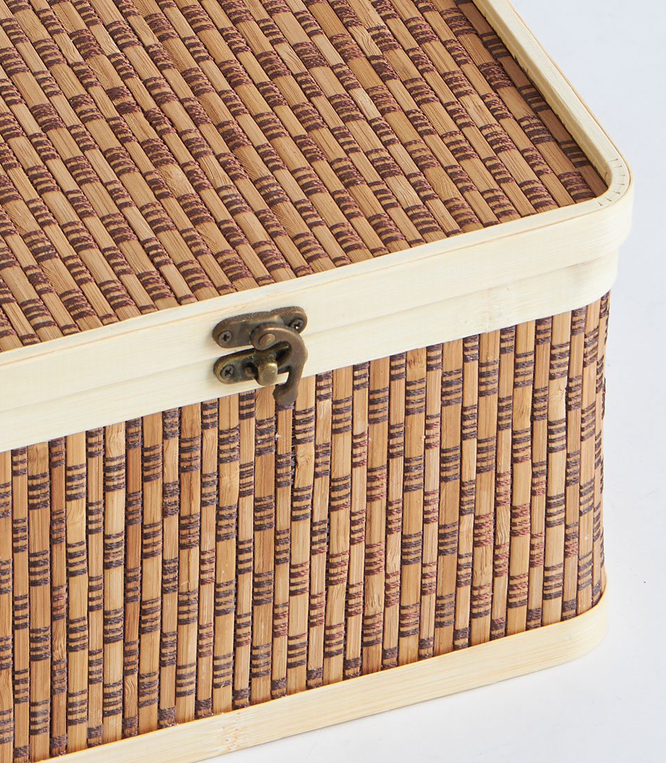 Handwoven bamboo picnic basket with brass clasp, natural light wood trim and diagonal lattice lid