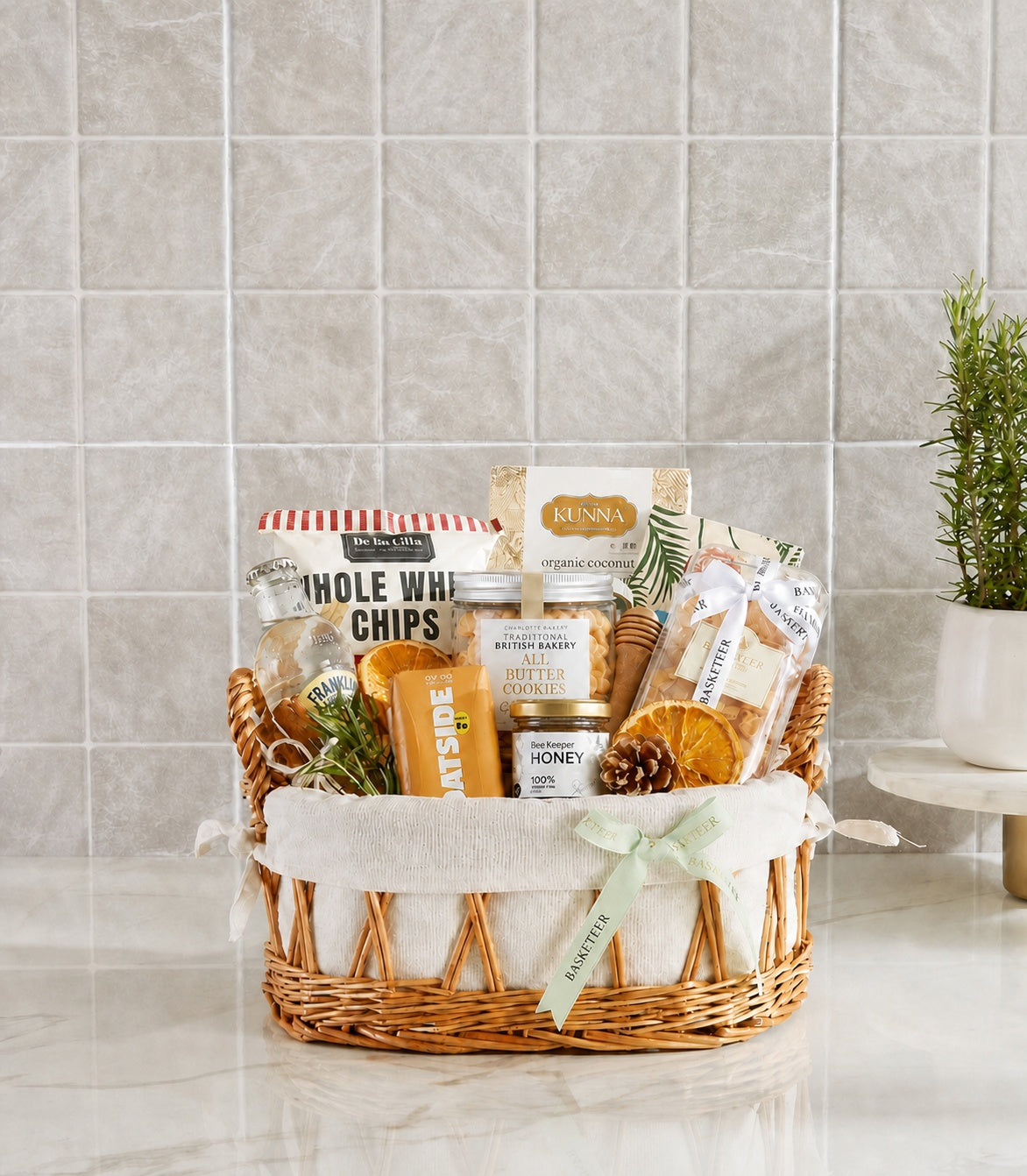 Basketeer premium hamper with woven wicker basket, white liner, and mint green